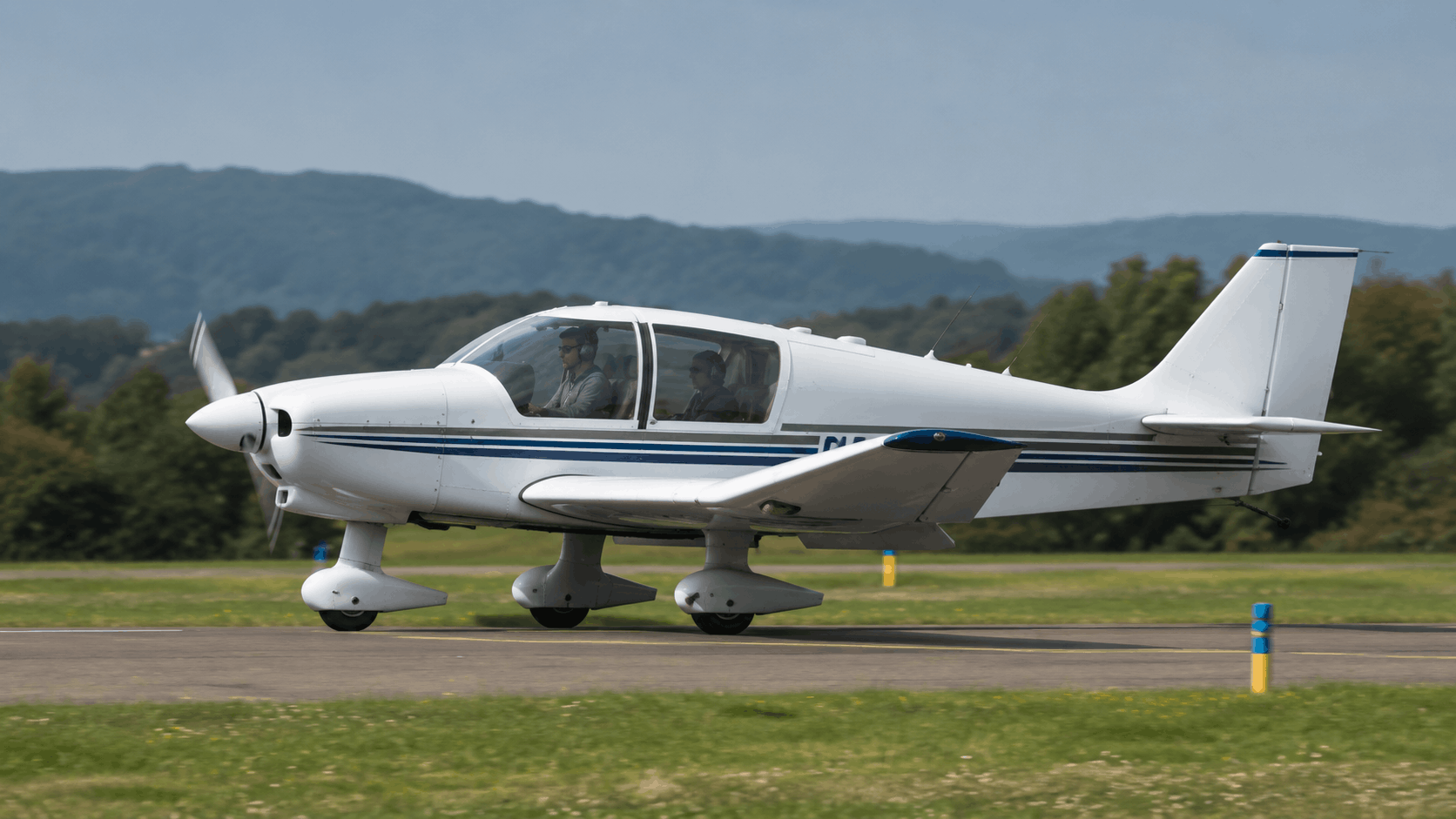 Pilot inspecting a classic light aircraft before departure