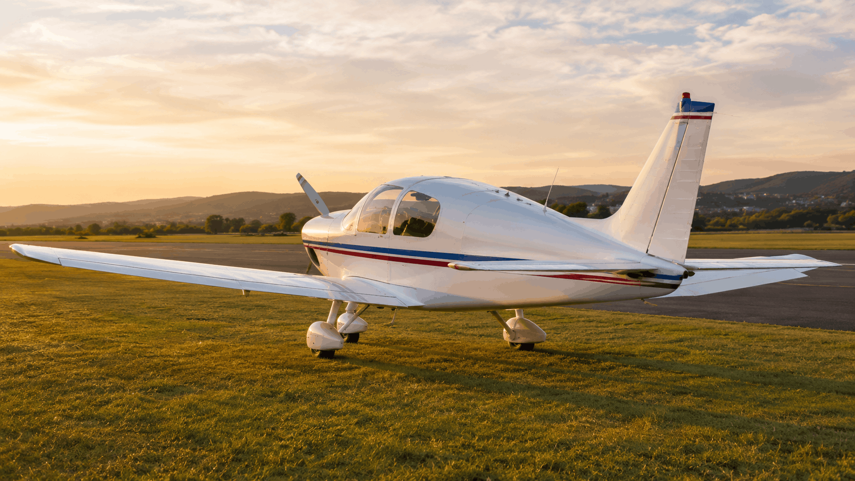 Robin HR100/210D-style touring aircraft in flight over countryside