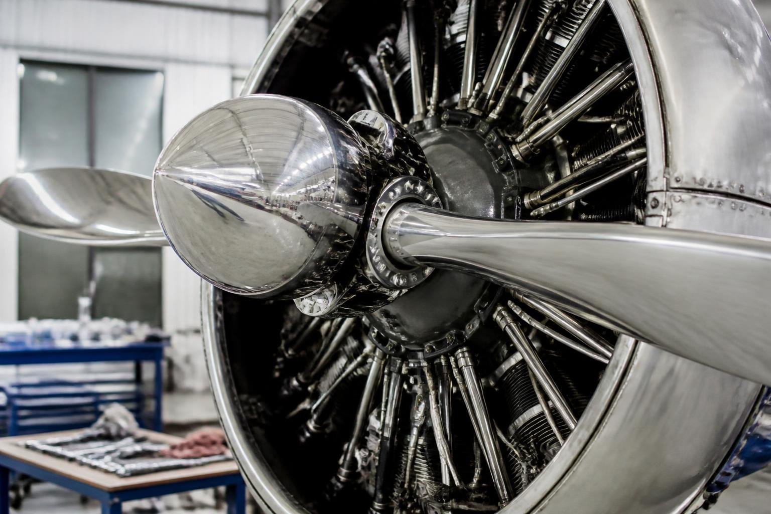 Close view of a radial aircraft engine in a maintenance hangar