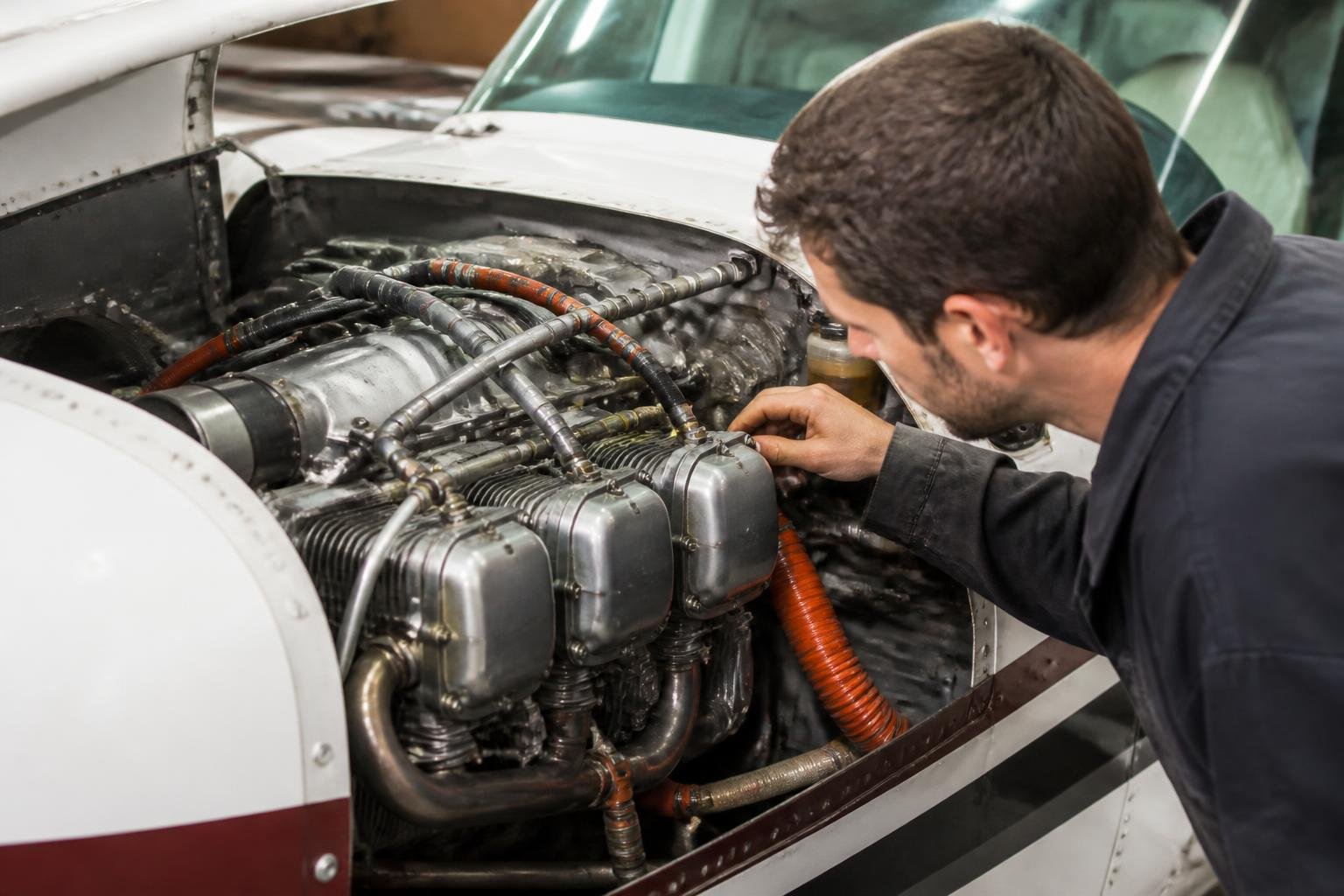 Mechanic inspecting a Rotax-powered Van's RV-12-style aircraft