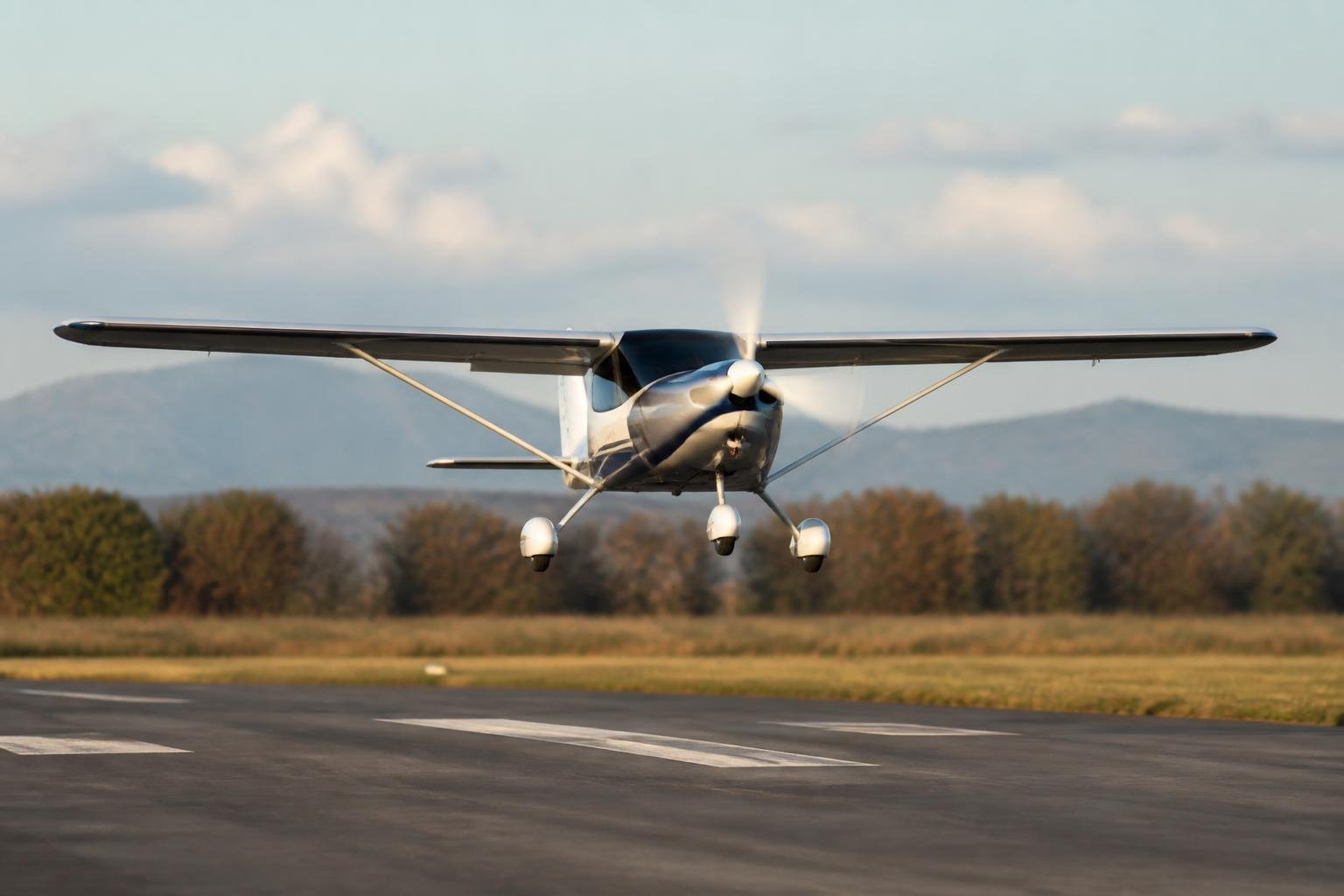Light sport aircraft approaching a paved runway