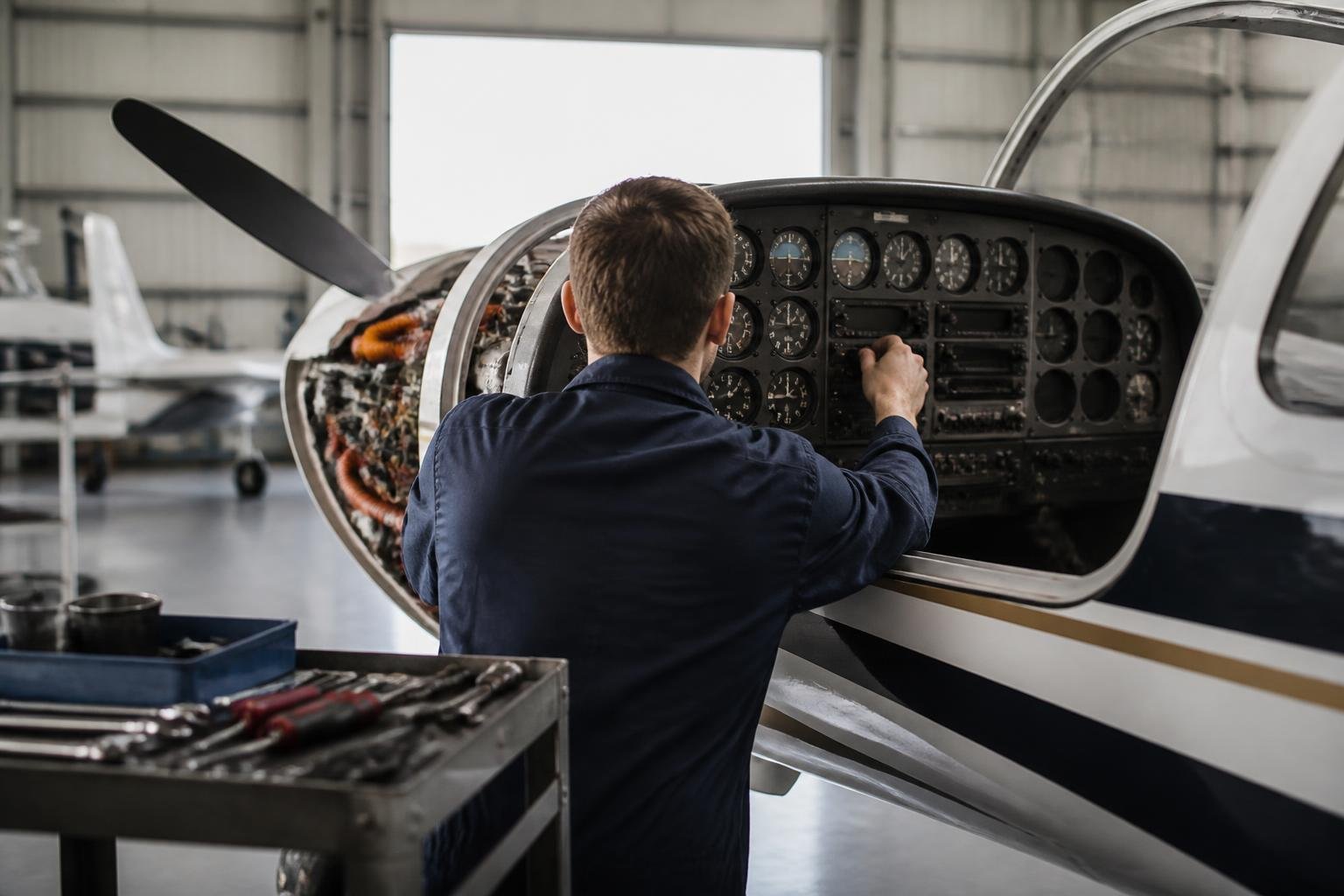 Technician inspecting avionics during aircraft maintenance
