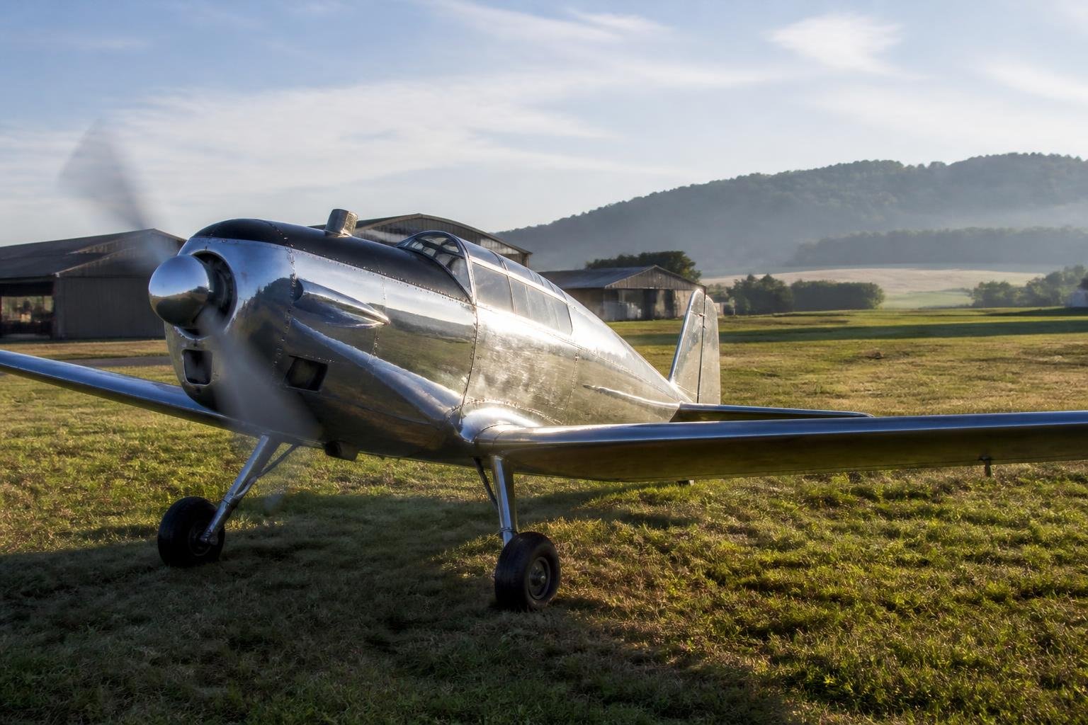Vintage taildragger parked at a European grass airfield