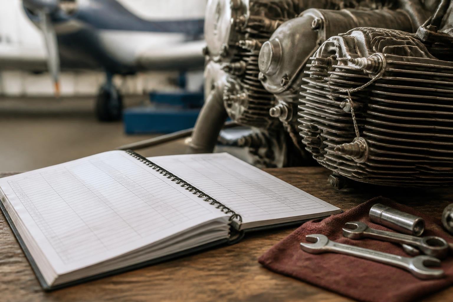 Aircraft engine maintenance records beside piston-engine components