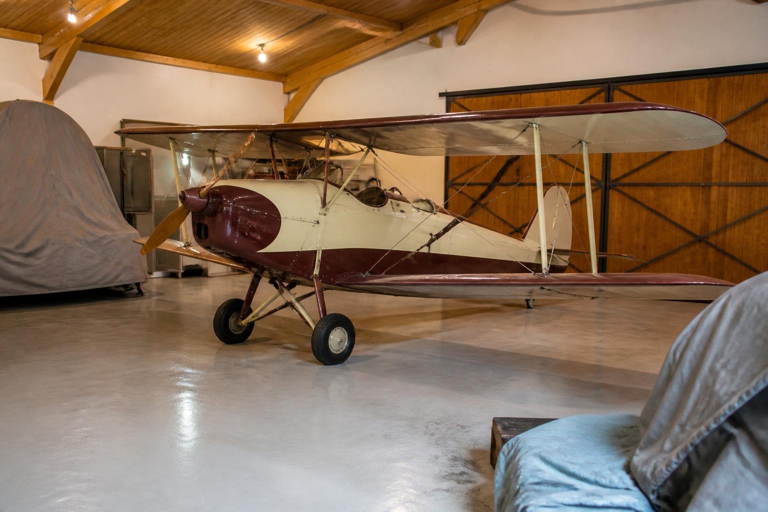 Vintage biplane stored inside a spacious private hangar